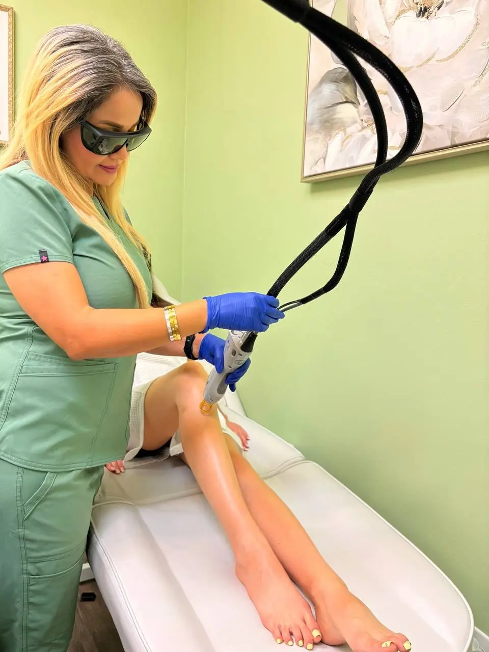 A Lium Laser specialist treating a client's lower leg